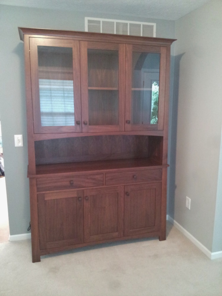 Walnut china hutch with undermount lighting.